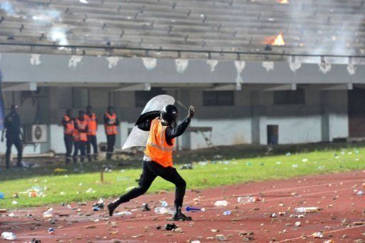 A policeman charges during crowd trouble at L&Atilde;&copy;opold S&Atilde;&copy;dar Senghor stadium in Dakar on October 13