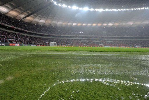 Water covers the grass at the stadium in Warsaw