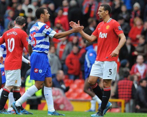 Anton Ferdinand shakes hands with brother Rio (R) in April