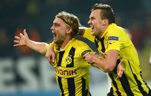 Dortmund&#039;s Marcel Schmelzer (L) celebrates scoring with Kevin Grosskreutz