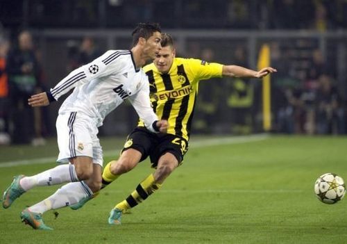 Real Madrid's Cristiano Ronaldo (L) and Dortmund's Lukasz Piszczek