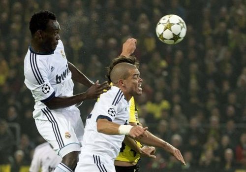 Real Madrid's Michael Essien (L) rises above teammate Pepe (C) and Dortmund's Mats Hummels for a header