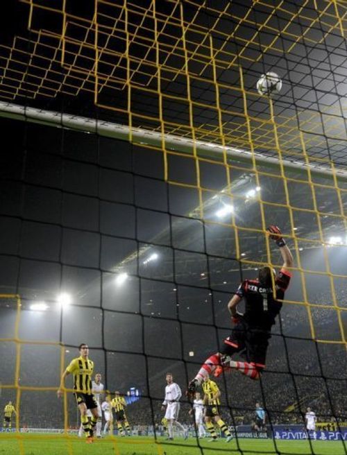 Dortmund's Robert Lewandowski has an attempt on goal pushed over by Real Madrid's goalkeeper Iker Casillas