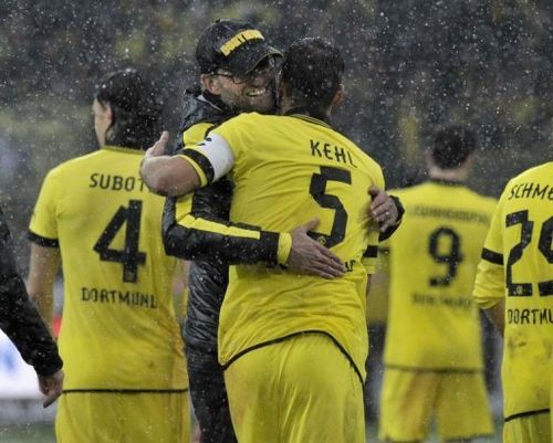 Dortmund's headcoach Juergen Klopp hugs midfielder Sebastian Kehl