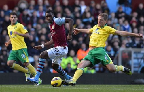 Aston Villa's striker Christian Benteke (2nd L) clashes with Norwich City's defender Michael Turner (R)