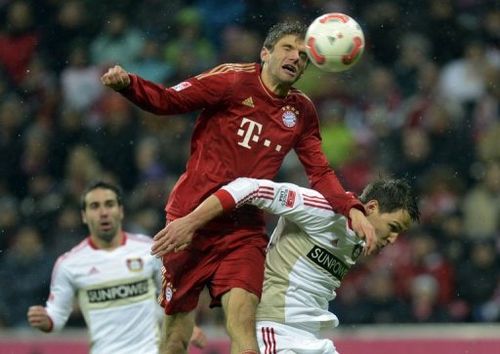 Bayern Munich's Thomas Mueller (C) and Leverkusen's Philipp Wollscheid (R)