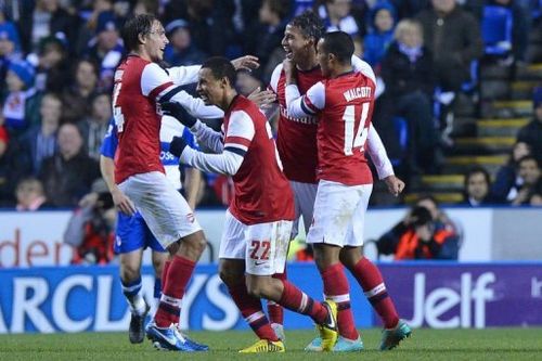 Arsenal's Marouane Chamakh (2nd R) celebrates with teammates after scoring