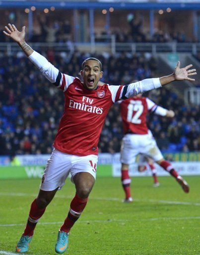 Arsenal&#039;s Theo Walcott celebrates their late fourth goal against Reading