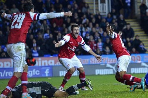 Arsenal's English striker Theo Walcott (R) celebrates scoring Arsenal's sixth goal against Reading