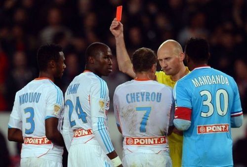 Marseille's Rod Fanni (2nd L) is given a red card by referee Antony Gautier