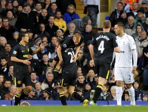 Wigan Athletic&#039;s midfielder Ben Watson (3rd L) is lifted by defender Ivan Ramis (2nd L) while celebrating his goal