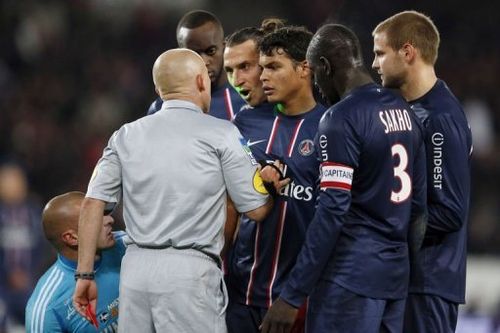 French referee Laurent Duhamel (2ndL) gives a red card to Paris Saint-Germain's forward Zlatan Ibrahimovic (C)