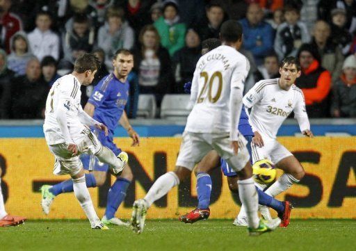 Swansea City&#039;s midfielder Pablo Hernandez (L) scores against Chelsea