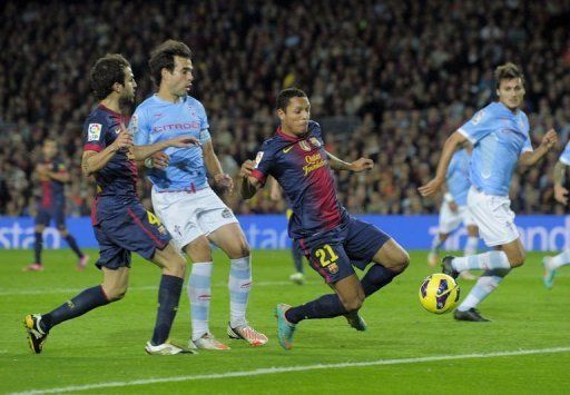 Barcelona&#039;s defender Adriano Correia (C) scores