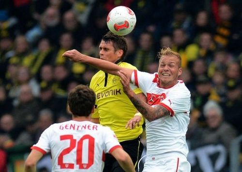 Dortmund's midfielder Sebastian Kehl (C) and Stuttgart's midfielder Raphael Holzhauser (R) jump for the ball