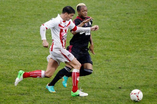 Ajaccio&#039;s Carl Medjani (L) vies with Marseille&#039;s Jordan Ayew