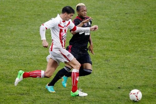 Ajaccio's Carl Medjani (L) vies with Marseille's Jordan Ayew