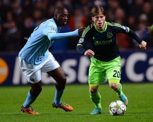 Ajax's Lasse Schone (R) vies with Manchester City's Yaya Toure