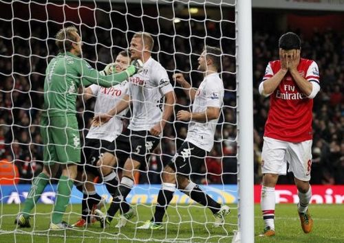 Fulham's goalkeeper Mark Schwarzer (L) celebrates saving the penalty taken by Arsenal's Mikel Arteta (R)