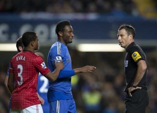 Chelsea&#039;s John Mikel Obi (2nd R) talking with referee Mark Clattenburg (R) in October