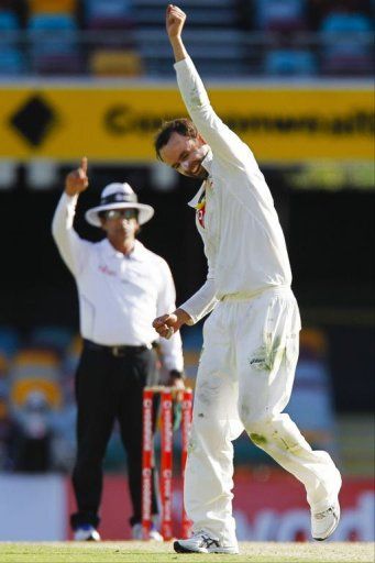 Australian bowler Nathan Lyon punches the air after claiming the wicket of South African batsman Jacques Rudolph