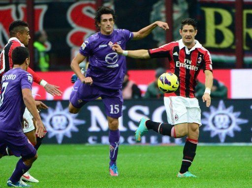 Pato (R) fights for the ball with Stefan Savic during the game