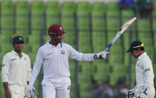 West Indies' Denesh Ramdin acknowledges the crowd after reaching his half century during the first day of the first Test