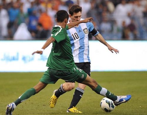 Saudi Arabia's Salman al-Faraj challenges Argentina's forward Lionel Messi (back)