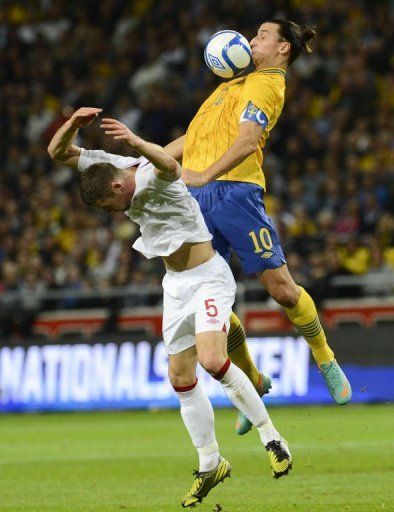 Sweden&#039;s Zlatan Ibrahimovic (L) vies for the ball with England&#039;s Gary Cahill