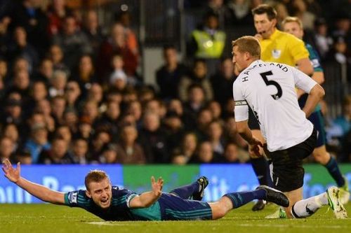 Sunderland's Lee Cattermole (L) reacts after being tackled by Fulham's Brede Hangeland