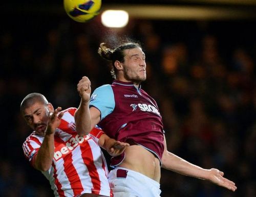 West Ham's Andy Carroll (R) jumps for the ball against Stoke's Jon Walters