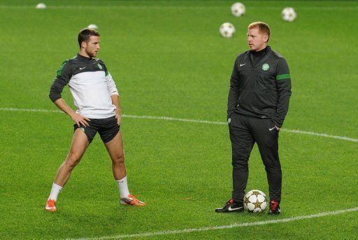 Celtic defender Adam Matthews (L) and coach Neil Lennon take part in a training session at Luz Stadium