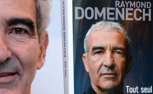 Raymond Domenech poses with his book 