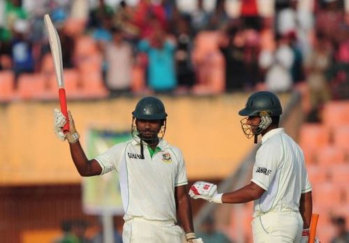 Bangladesh's No. 10 batsmen Abul Hasan (L) acknowledges the crowd after scoring a half century