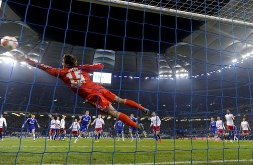 Hamburg's goalkeeper Rene Adler saves a free-kick against Schalke 04 on November 27