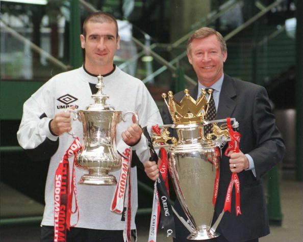 File Photo: Manchester United manager Alex Ferguson and Eric Cantona with the FA Cup and Premiership trophy.