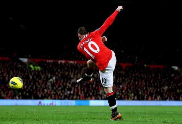 MANCHESTER, ENGLAND - DECEMBER 10:  Wayne Rooney of Manchester United lashes a shot towards the Wolves goal to score his team&#039;s fourth goal during the Barclays Premier League match between Manchester United and Wolverhampton Wanderers at Old Trafford on December 10, 2011 in Manchester, England.  