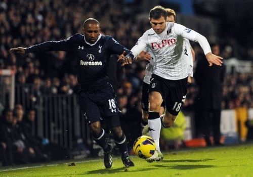 Tottenham Hotspur's striker Jermain Defoe (L) clashes with Fulham's defender Aaron Hughes