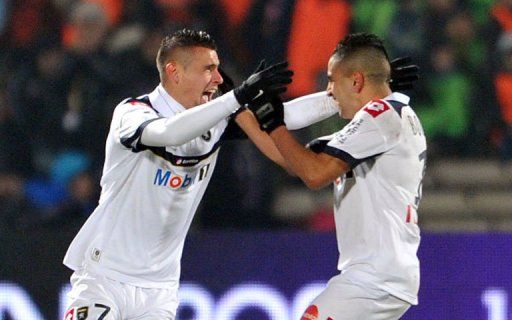 Sochaux&#039; forward Rafael Dias (L) is congratulated by his teammate Ryad Boudebouz after scoring a goal