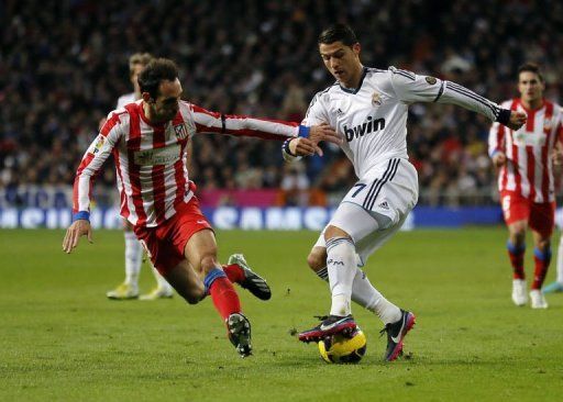 Real Madrid&#039;s Cristiano Ronaldo (R) responded on 15 minutes with a free-kick from 30 yards which nestled in the corner