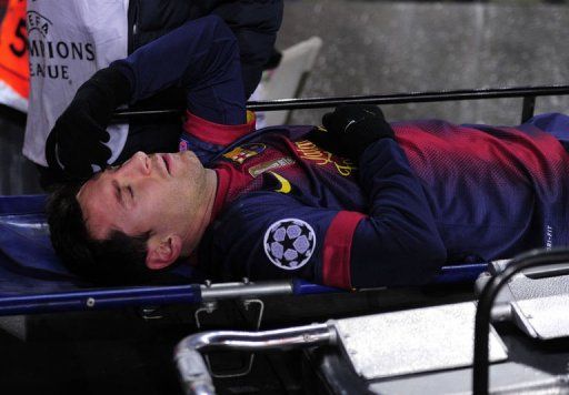 Barcelona&#039;s forward Lionel Messi leaves the pitch on a stretcher