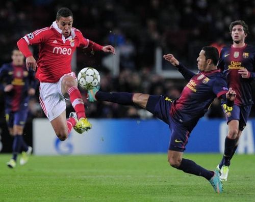 Benfica's forward Rodrigo Moreno Machado (L) clashes with Barcelona's defender Adriano Correia (R)