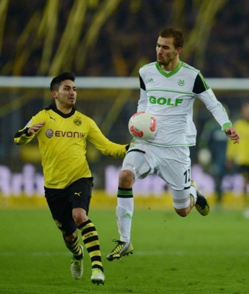 Wolfsburg's striker Bas Dost (R) and Dortmund's midfielder Ilkay Guendogan fight for the ball