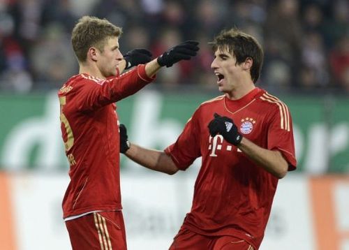 L-R: Bayern Munich's midfielder Javi Martinez and striker Thomas Mueller celebrate