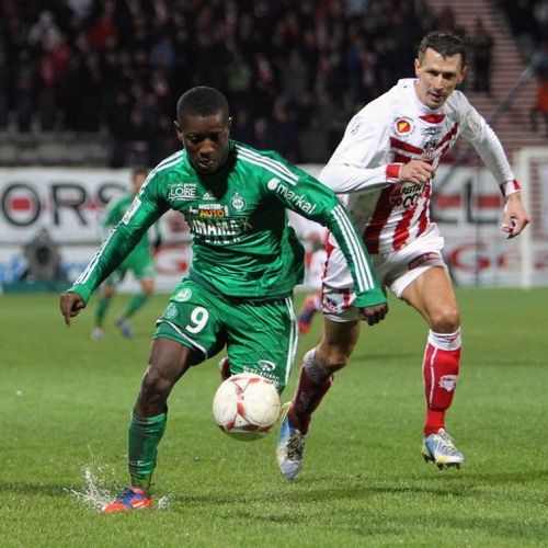 Saint-Etienne's Max Alain Gradel (L) fights for the ball with Ajaccio's Yohan Poulard