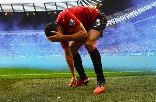 Rio Ferdinand was left bleeding after appearing to be struck in the face by an object thrown from the Etihad crowd