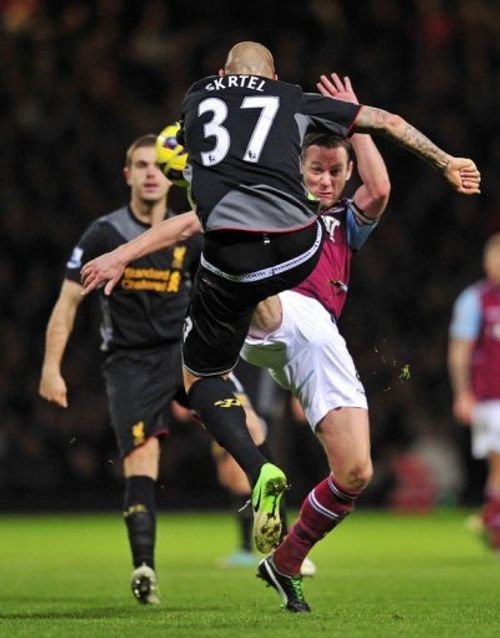 West Ham's Kevin Nolan (R) vies with Liverpool's Martin Skrtel