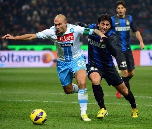 Inter Milan's Diego Milito (R) fights for the ball with Napoli's Paolo Cannavaro