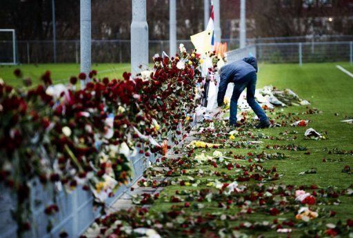 A man places flowers at Richard Nieuwenhuizen&#039;s memorial site in Almere, Netherlands