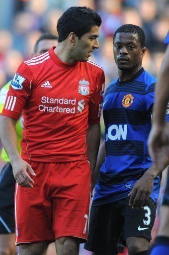 Luis Suarez (L) was hit with an eight-match suspension last year for racially abusing Patrice Evra (R)
